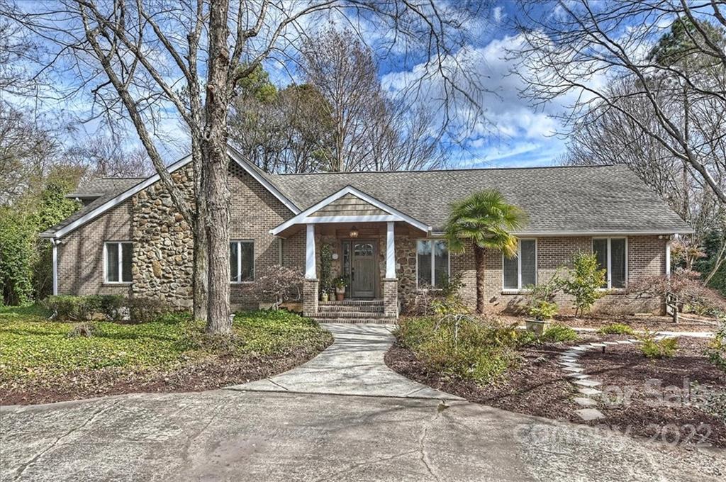 8025 Rising Meadow Road Charlotte, NC 28277 - Photo 1 of 48 a front view of a house with a yard and potted plants