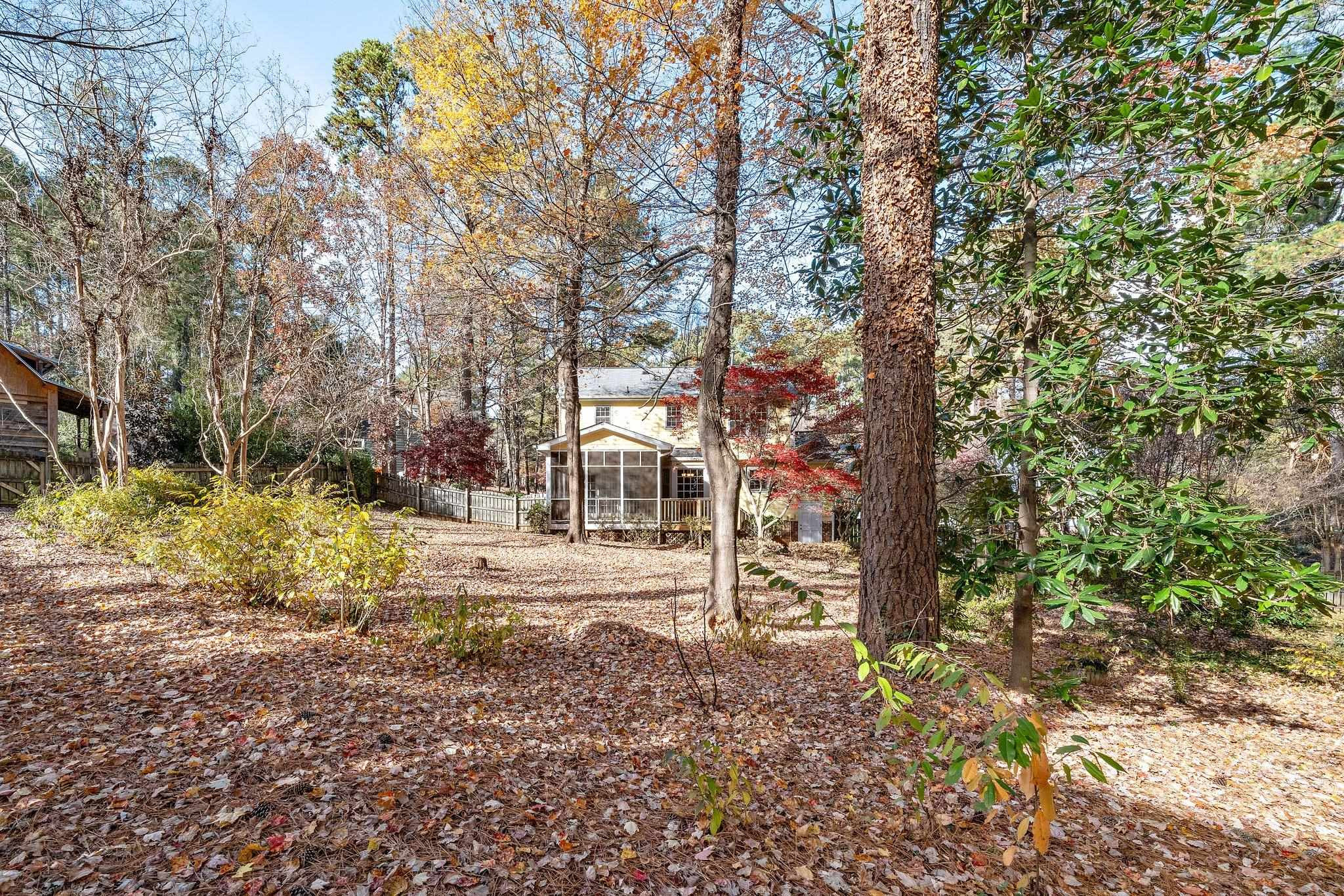 5801 Heatherbrook Circle Raleigh, NC 27612 - Photo 4 of 28 a view of a yard with plants and trees