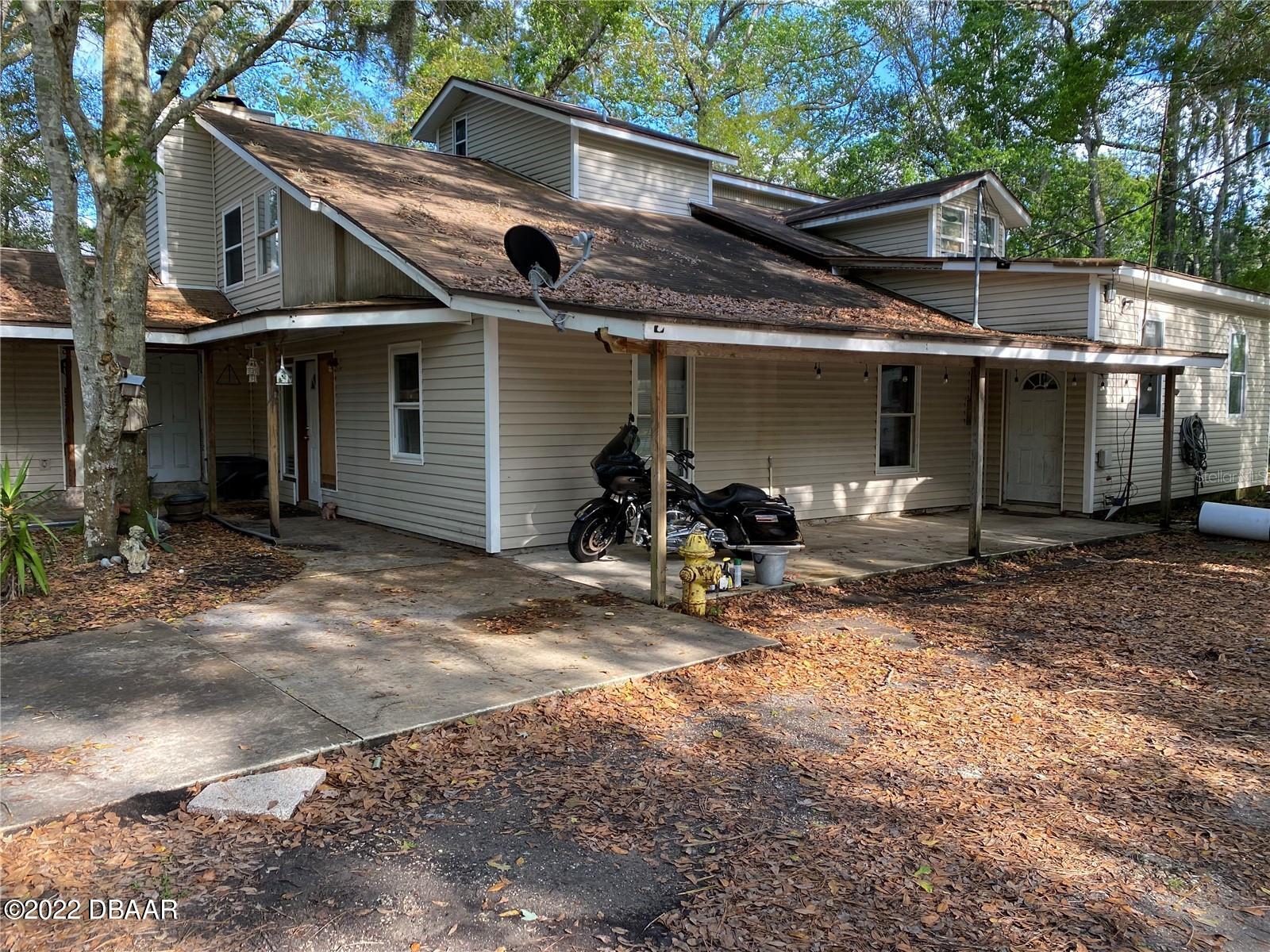 4580 Ave D St. Augustine, FL 32095 - Photo 2 of 10 a view of a white house with large windows and a small yard
