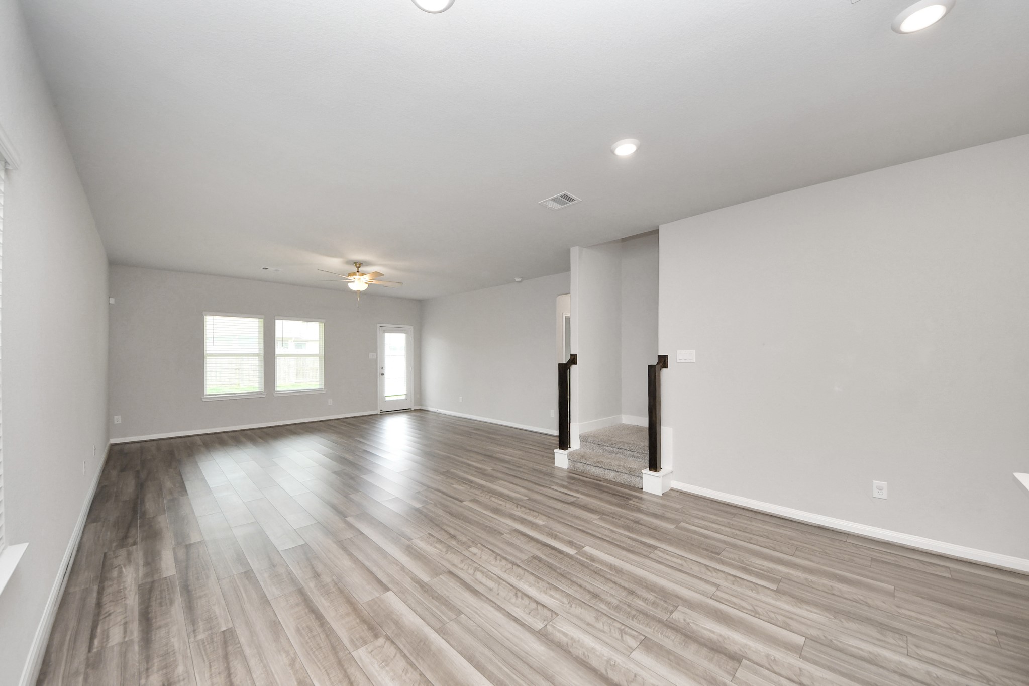 7206 Melrose Lane Rosharon, TX 77583 - Photo 14 of 44 wooden floor in an empty room with a window