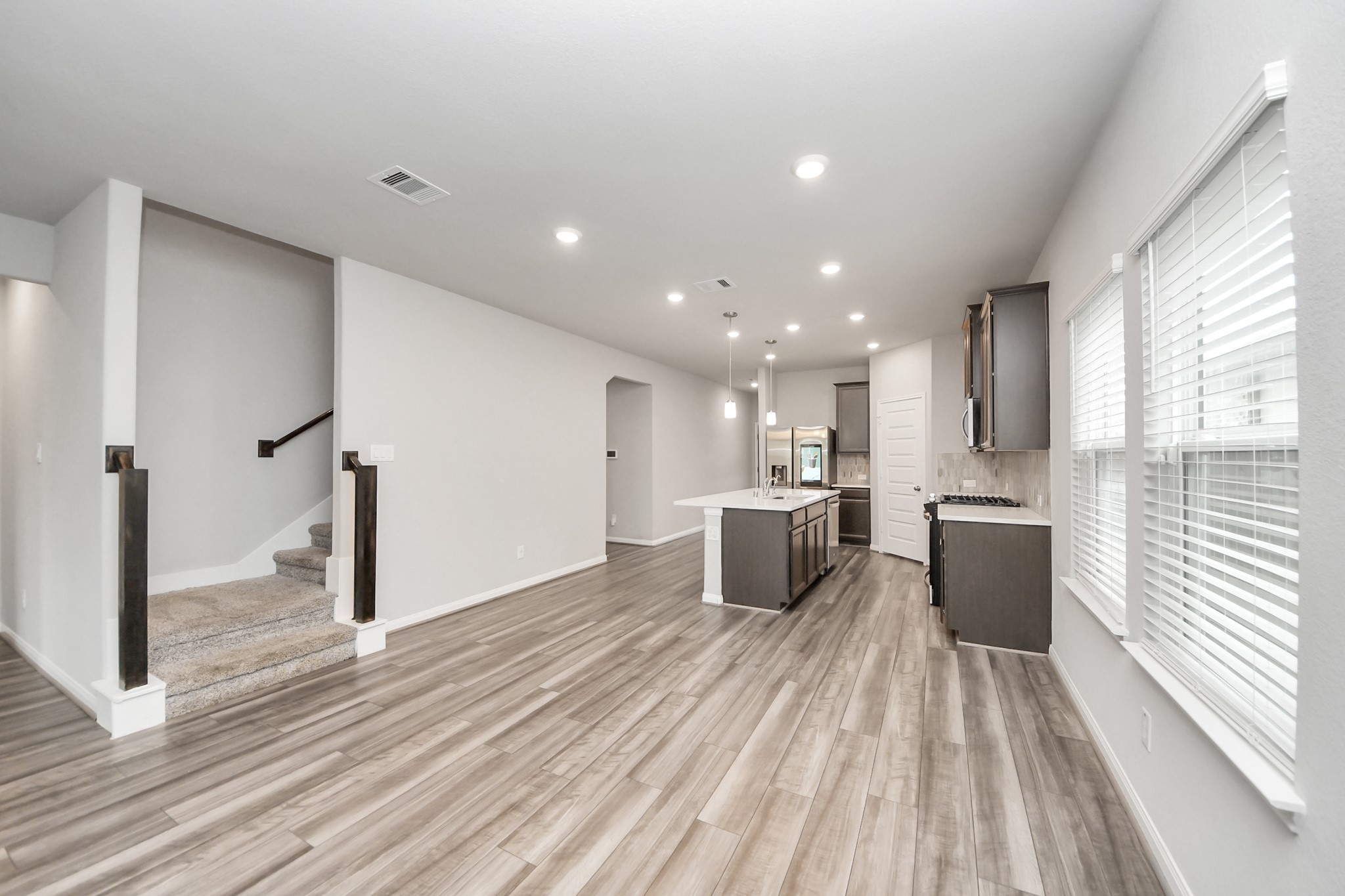 7206 Melrose Lane Rosharon, TX 77583 - Photo 15 of 44 a view of a kitchen with kitchen island wooden floors granite counter tops and a window