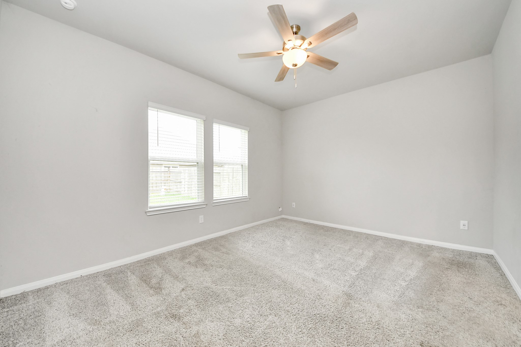 7206 Melrose Lane Rosharon, TX 77583 - Photo 21 of 44 an empty room with a window and a fan