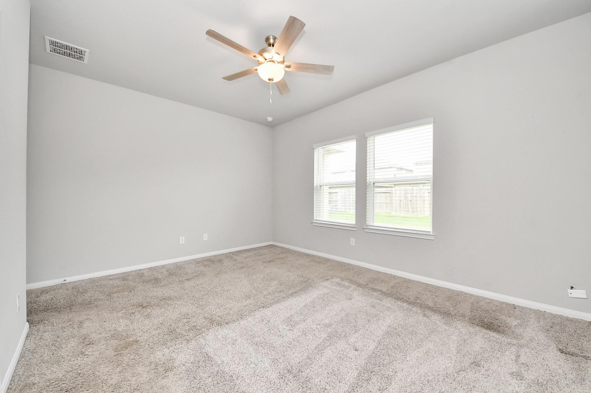 7206 Melrose Lane Rosharon, TX 77583 - Photo 23 of 44 an empty room with windows and fan