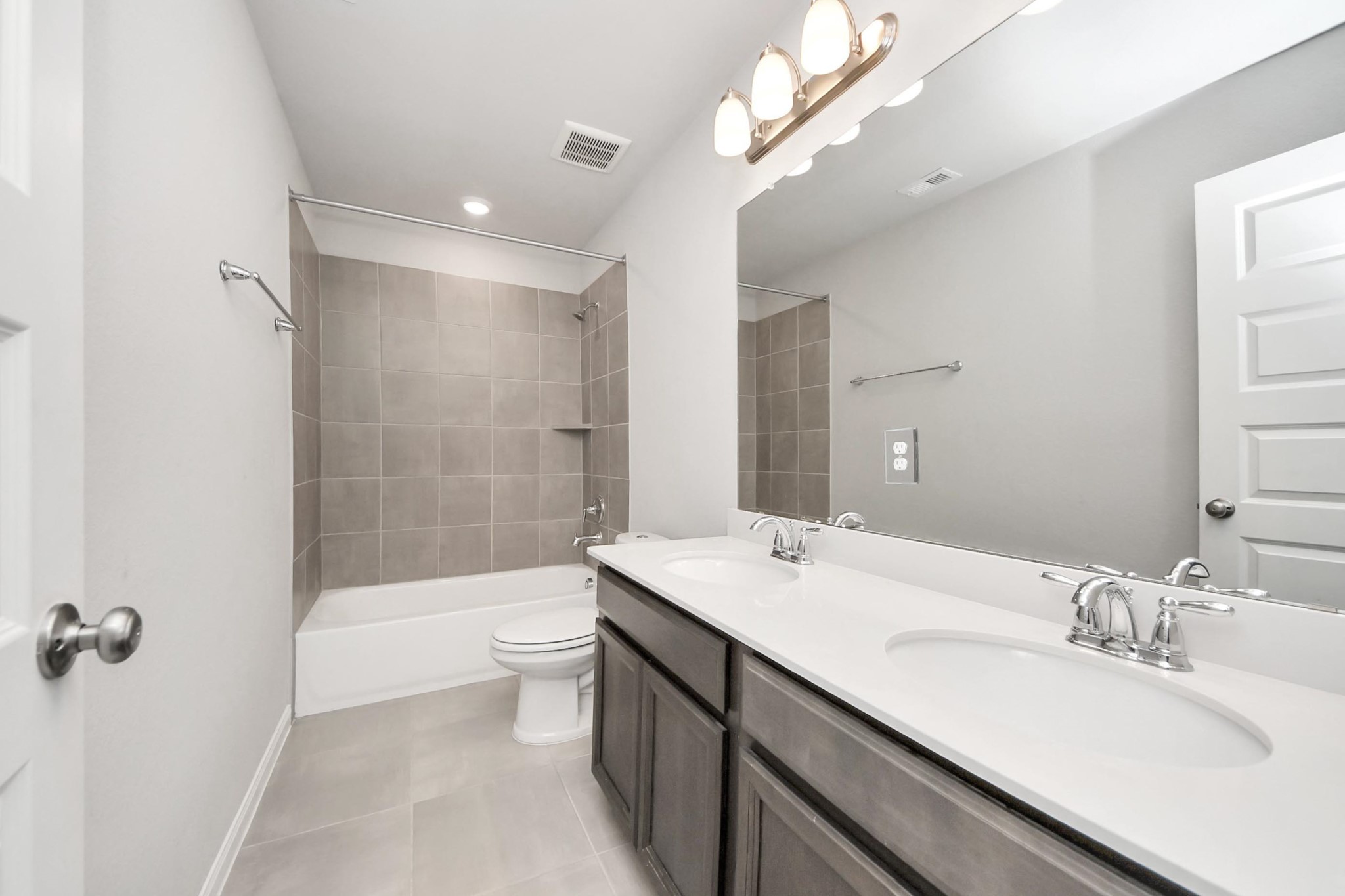 7206 Melrose Lane Rosharon, TX 77583 - Photo 31 of 44 a bathroom with a double vanity sink toilet mirror and bathtub