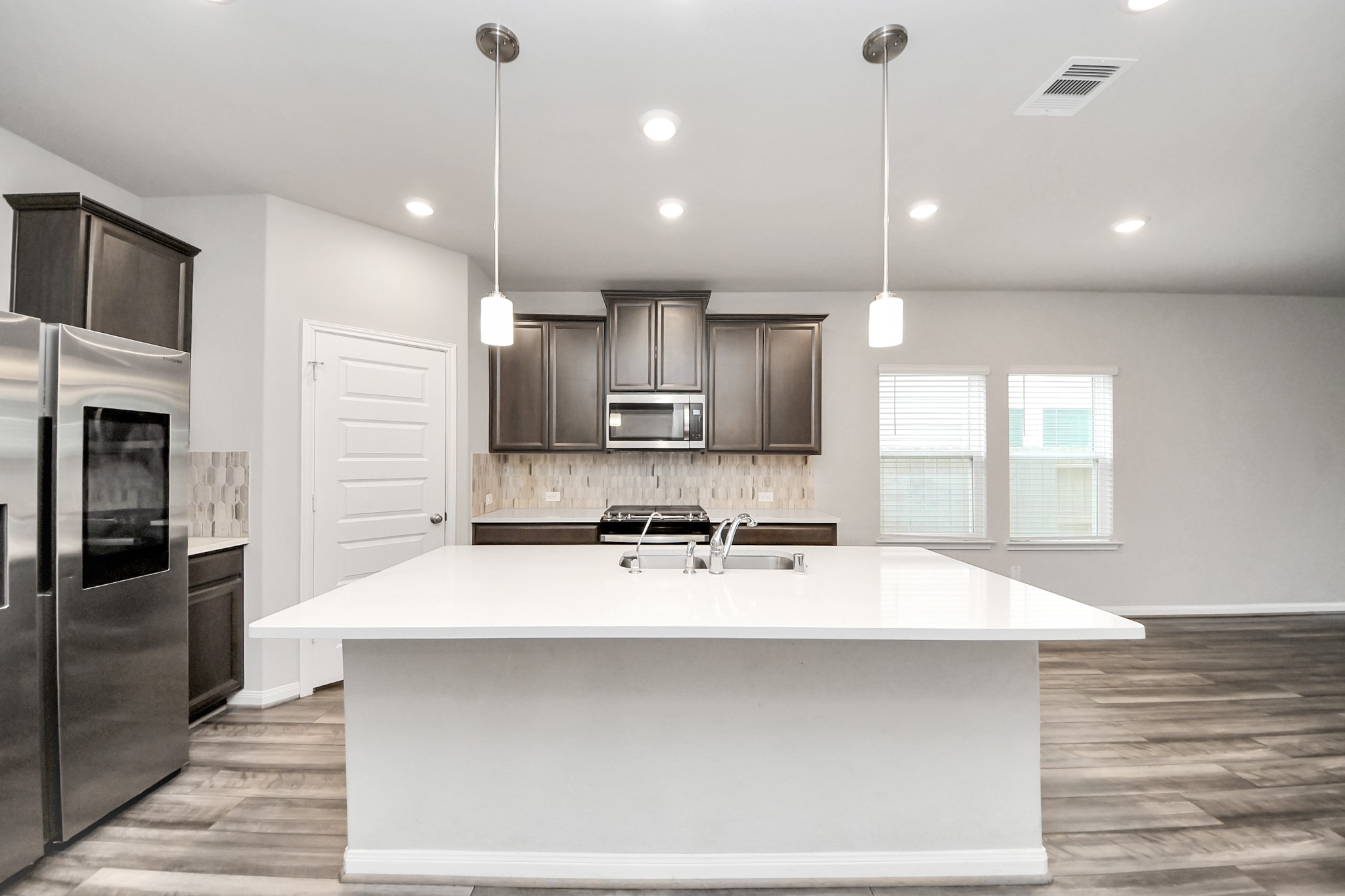 7206 Melrose Lane Rosharon, TX 77583 - Photo 7 of 44 a large kitchen with a large counter top appliances and cabinets