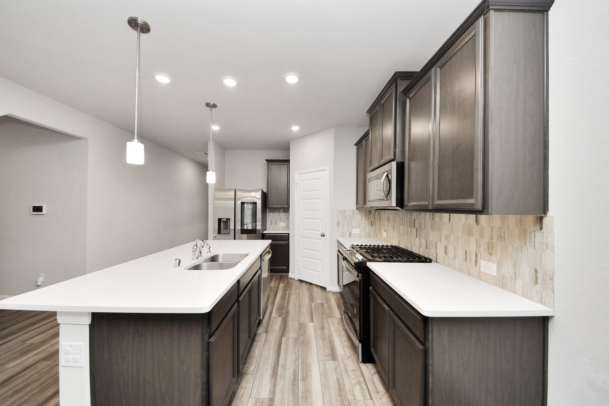 7206 Melrose Lane Rosharon, TX 77583 - Photo 8 of 44 a kitchen with a sink and refrigerator