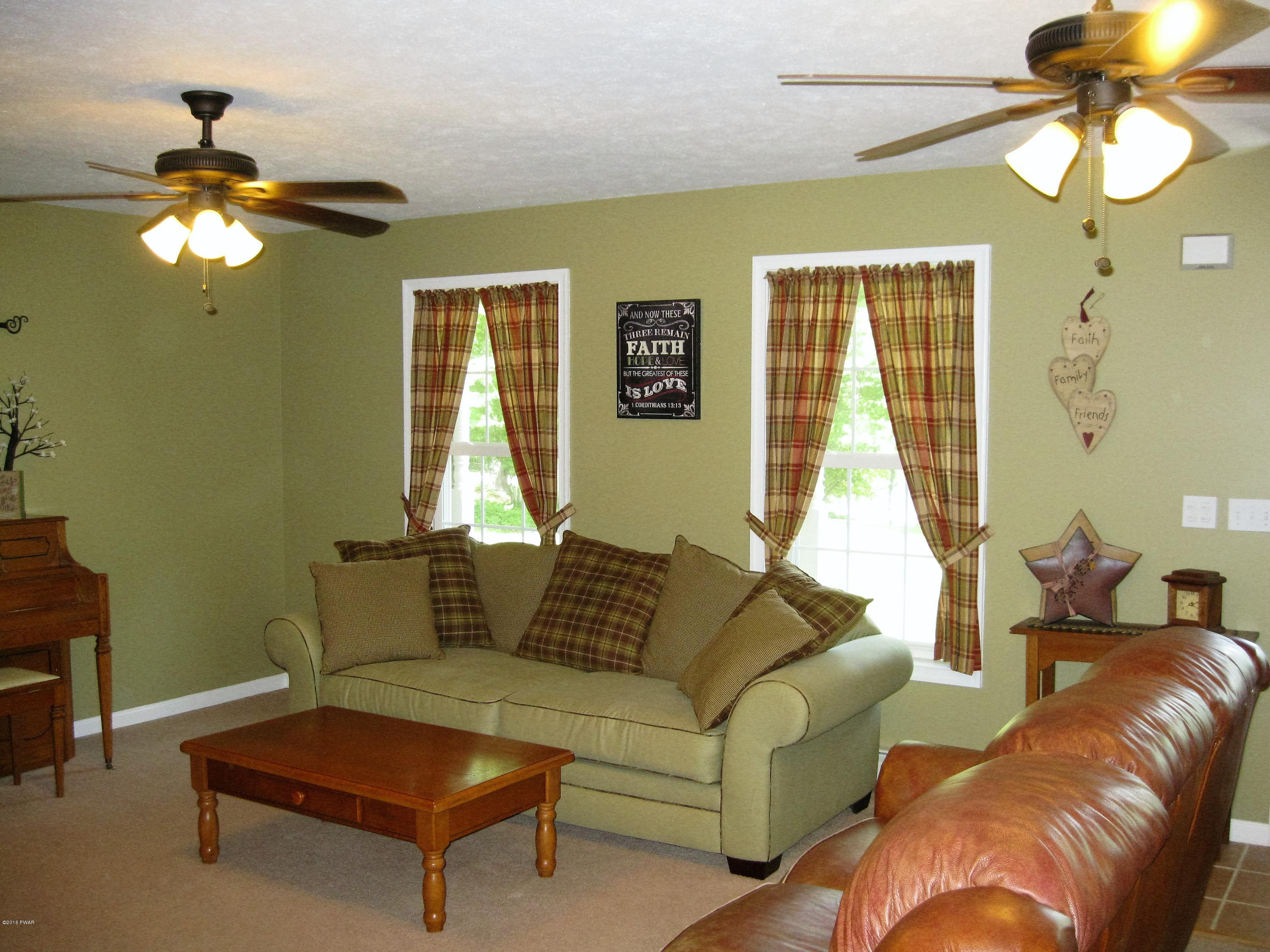 137 Caribou Road Dingmans Ferry, PA 18328 - Photo 8 of 34 a living room with furniture and a window