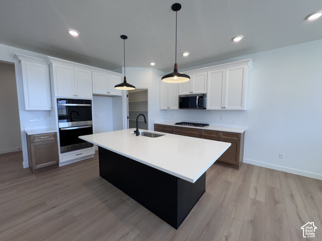 2613 Scarlet Road, Unit 258 Eagle Mountain, UT 84005 - Photo 7 of 30 Kitchen featuring a large island with sink, pendant lighting, built-in double oven, and wood-finish flooring