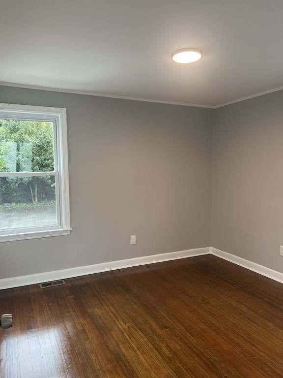 135 Snell Street Fall River, MA 02721 - Photo 12 of 29 a view of an empty room with wooden floor and a window