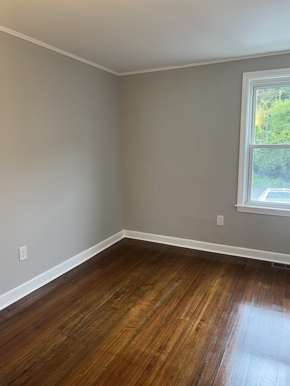 135 Snell Street Fall River, MA 02721 - Photo 13 of 29 a view of an empty room with wooden floor and a window