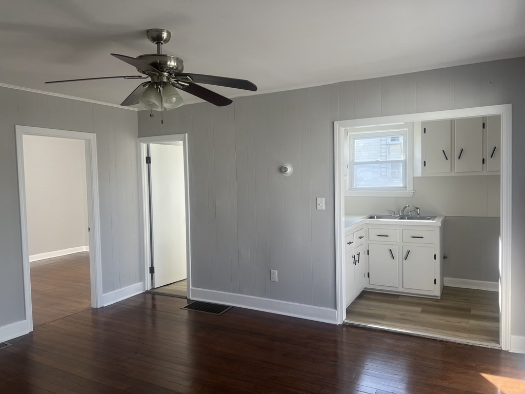 135 Snell Street Fall River, MA 02721 - Photo 17 of 29 an empty room with wooden floor chandelier fan and windows