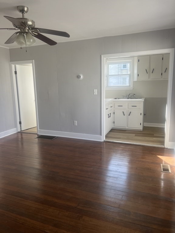 135 Snell Street Fall River, MA 02721 - Photo 18 of 29 an empty room with wooden floor fan and windows
