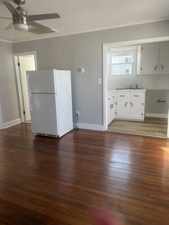135 Snell Street Fall River, MA 02721 - Photo 19 of 29 an empty room with wooden floor and cabinet