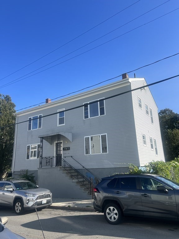 135 Snell Street Fall River, MA 02721 - Photo 2 of 29 a car parked in front of a house