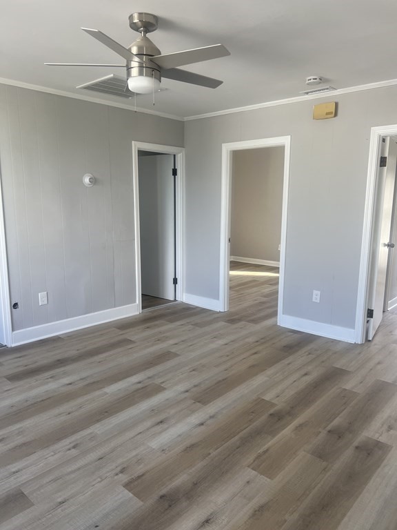 135 Snell Street Fall River, MA 02721 - Photo 28 of 29 an empty room with wooden floor closet and ceiling fan