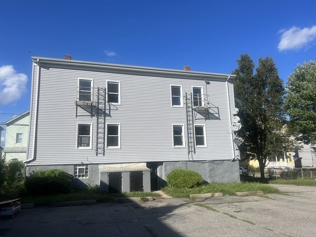 135 Snell Street Fall River, MA 02721 - Photo 5 of 29 a front view of a house with a yard