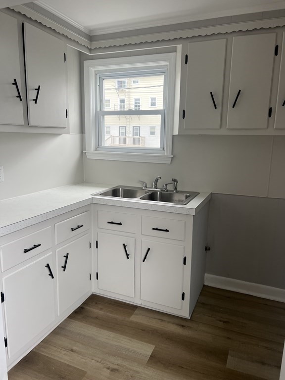 135 Snell Street Fall River, MA 02721 - Photo 9 of 29 a view of cabinets a sink and dishwasher with wooden floor