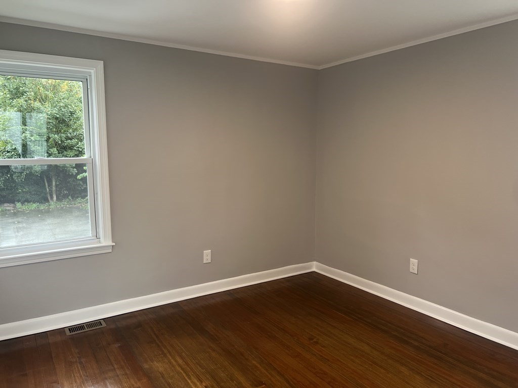 135 Snell Street Fall River, MA 02721 - Photo 10 of 29 a view of an empty room with wooden floor and a window