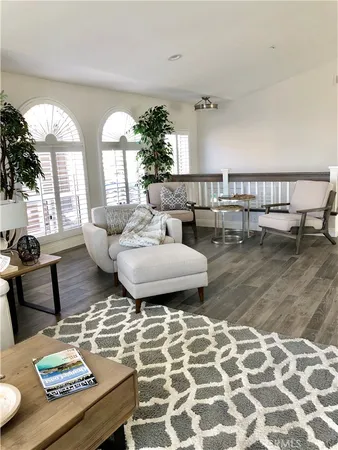 a living room with couches and a table with garden view