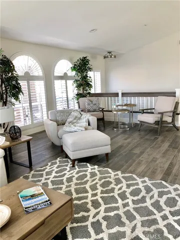 a living room with couches and a table with garden view
