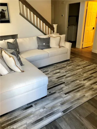 a bedroom with a bed and a lamp on a dresser