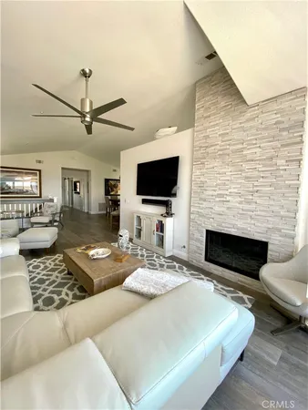 a living room with fireplace furniture and a flat screen tv