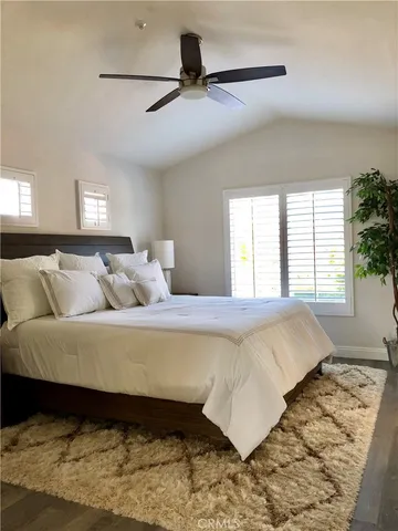 a bed sitting in a bedroom next to a window
