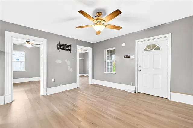 a view of an room with wooden floor and ceiling fan