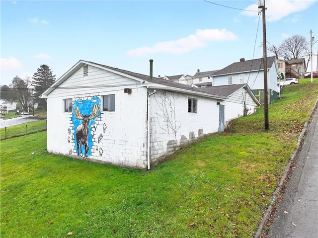 a view of a house with a yard and deck