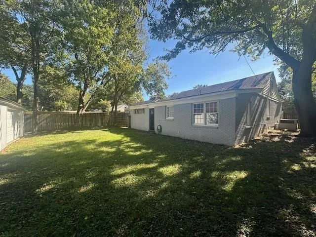a view of a yard with a large tree