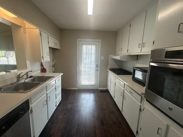 4416 Boyce Road Memphis, TN 38117 - Photo 3 of 22 Kitchen with light countertops, black appliances, dark wood-style flooring, and white cabinetry