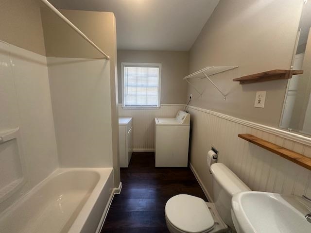 4416 Boyce Road Memphis, TN 38117 - Photo 4 of 22 Bathroom featuring bathtub / shower combination, washer and dryer, dark wood-style floors, and wainscoting