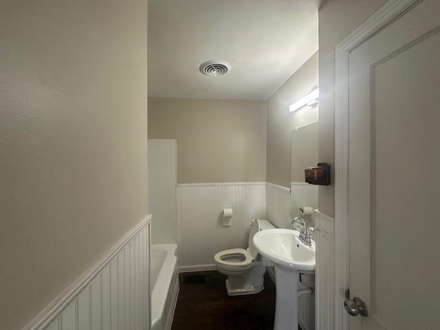 4416 Boyce Road Memphis, TN 38117 - Photo 6 of 22 Bathroom featuring wainscoting, radiator, and dark wood-type flooring