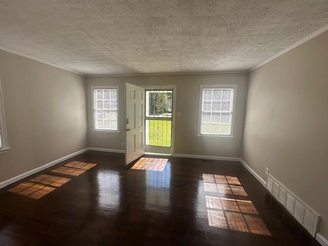 4416 Boyce Road Memphis, TN 38117 - Photo 10 of 22 Doorway to outside with a textured ceiling, wood finished floors, and ornamental molding
