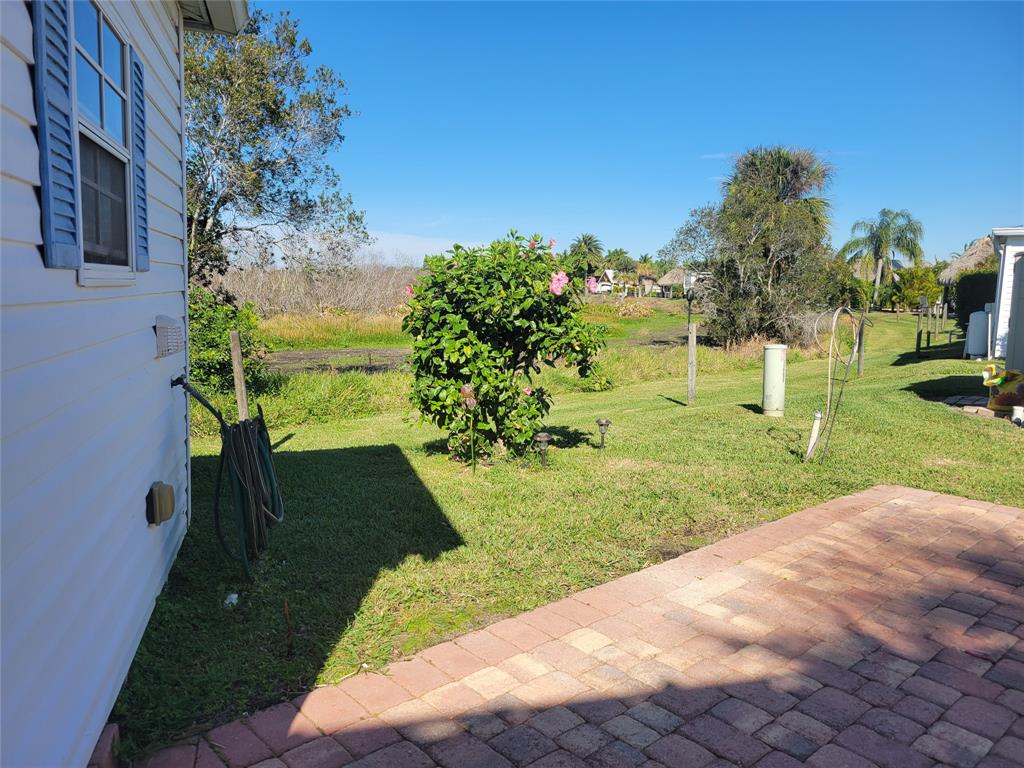 605 Southwest 40th Cove Okeechobee, FL 34974 - Photo 9 of 10 a view of a garden with a bench