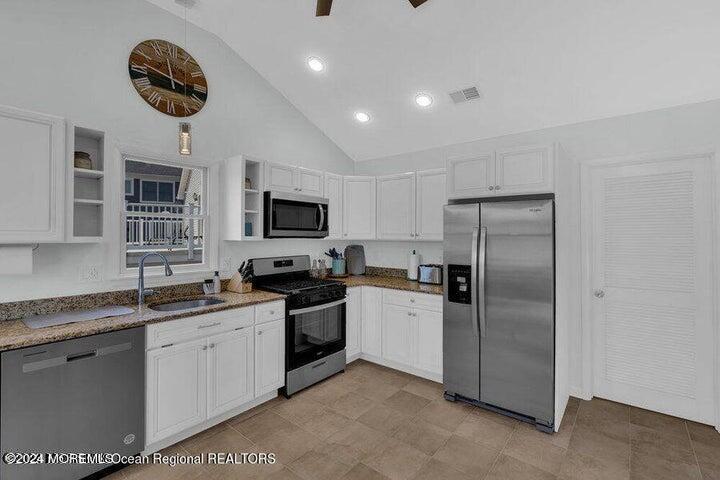 3125 Creek Road Toms River, NJ 08753 - Photo 21 of 60 a kitchen with stainless steel appliances granite countertop a sink a stove a refrigerator cabinets and a window
