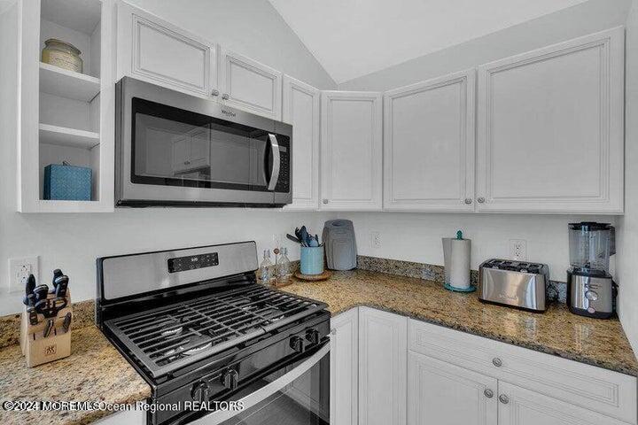 3125 Creek Road Toms River, NJ 08753 - Photo 22 of 60 a kitchen with granite countertop a stove and a sink