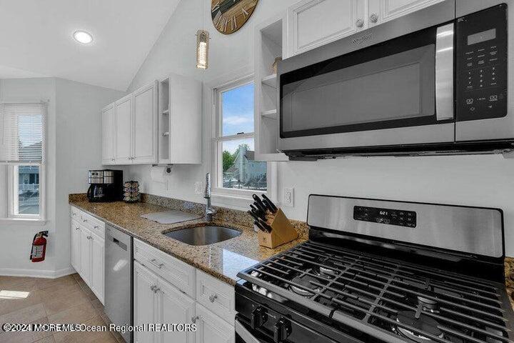 3125 Creek Road Toms River, NJ 08753 - Photo 23 of 60 a kitchen with a stove and a microwave