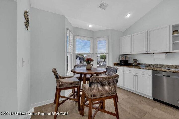 3125 Creek Road Toms River, NJ 08753 - Photo 25 of 60 a kitchen with a dining table chairs and white cabinets