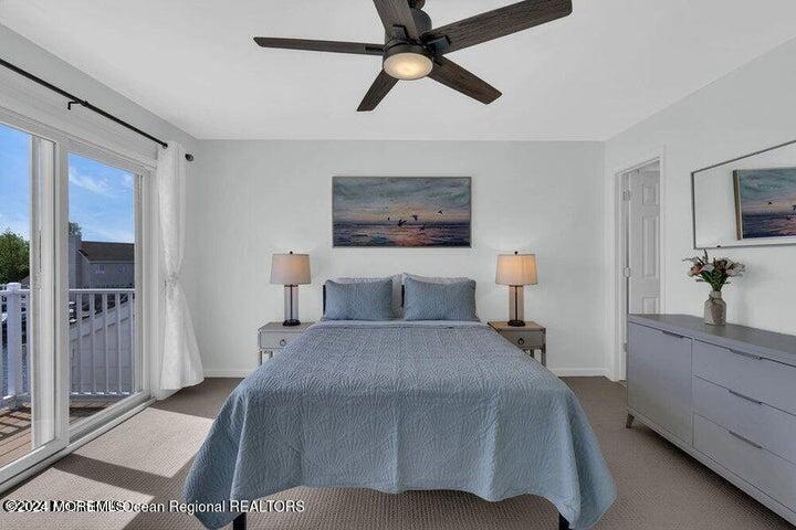 3125 Creek Road Toms River, NJ 08753 - Photo 32 of 60 a bedroom with a large bed a chandelier and a dresser