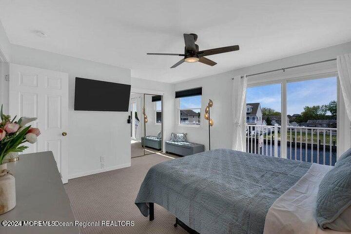 3125 Creek Road Toms River, NJ 08753 - Photo 34 of 60 a bedroom with a bed a flat screen tv and a large window