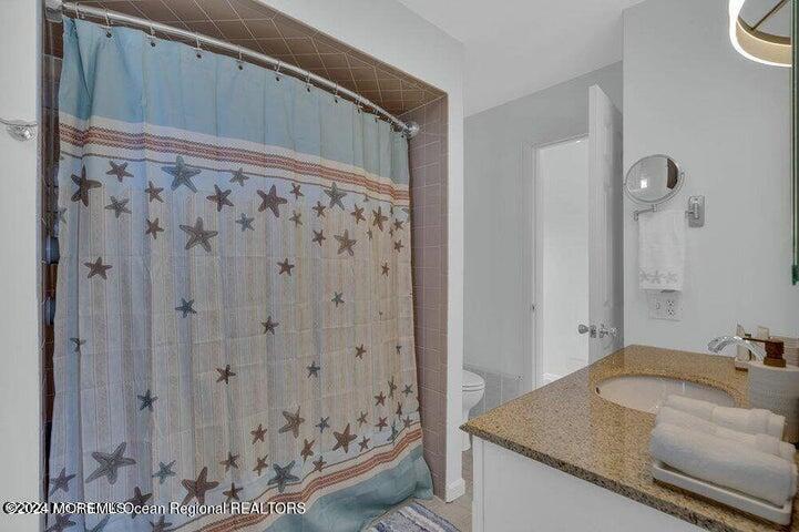 3125 Creek Road Toms River, NJ 08753 - Photo 35 of 60 a bathroom with a granite countertop sink and a mirror
