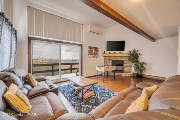 a spacious bedroom with a bed and a flat screen tv