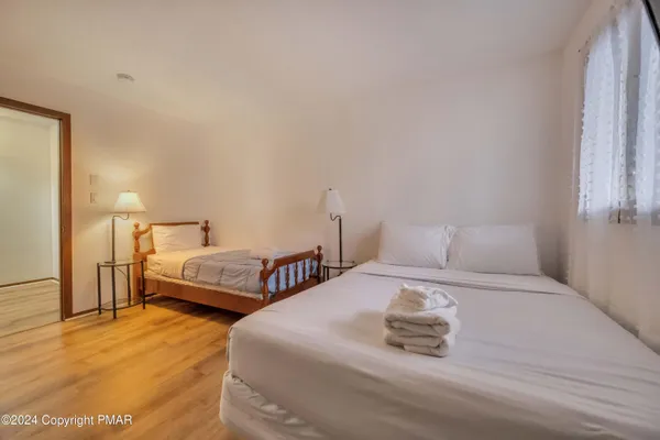 a bedroom with a bed and a chandelier