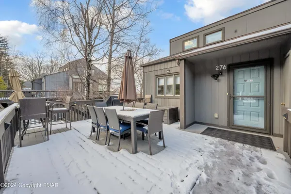 a view of a house with a wooden fence