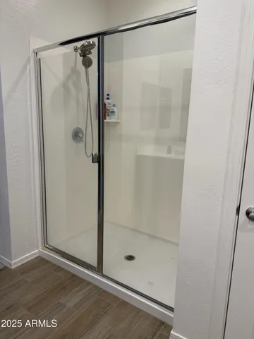 a bathroom with a glass shower door
