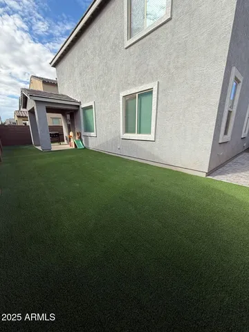 a view of an house with backyard space and porch