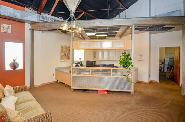 a view of living room with furniture and a chandelier