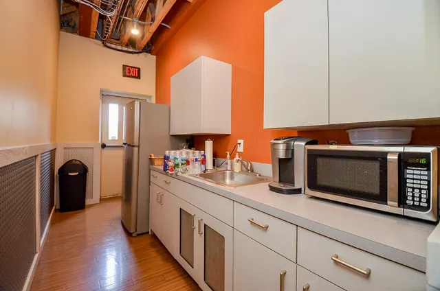 a kitchen with stainless steel appliances kitchen island granite countertop a stove a sink and a microwave