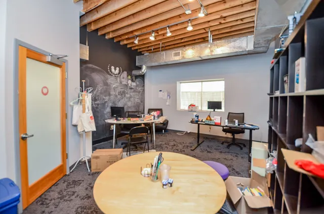 a living room with dining table and a fireplace